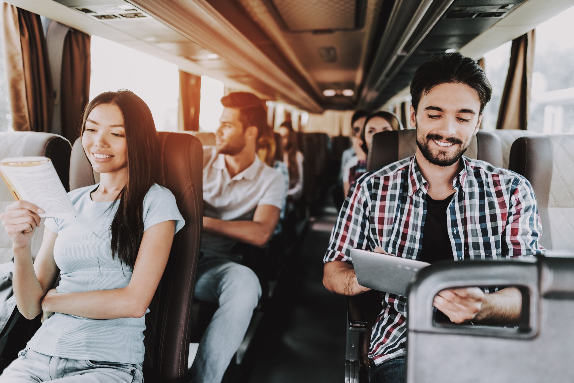 Young Smiling People Traveling on Tourist Bus
